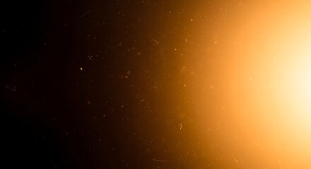 Abstract golden glowing light effect with shimmering dust particles creating a cinematic and atmospheric background overlay texture for creative designs