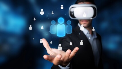 A man wearing a virtual reality headset reaches out to interact with glowing 3D avatars and digital icons, symbolizing connectivity and engagement in a high-tech future. Raster