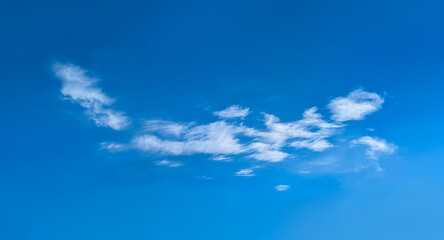 Structure of some cloud on the blue sky. White relaxed cottony form. Background serene sky. Fiber contours after rain. Lonely substance of water.