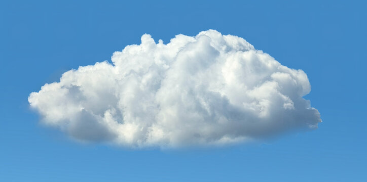 A big fluffy cumulus cloud with clear skies. A compound clouds slowly floats across the sky. Serenity and solitude. Calm and contemplation