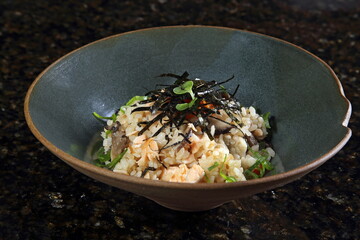 Shake no takikomi gohan, salmon cooked with rice. Takikomi-gohan is rice in a soy sauce-based mixture with ingredients that create a flavorful broth. Made with rice, salmon fillets, enoki mushrooms, c