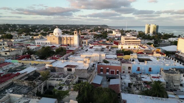 flying above scenic colorful colonial street in campeche yucatan peninsula (spanish architecture streetscape scene) gulf mexico sunrise glow cornice building beautiful downtown city center aerial view