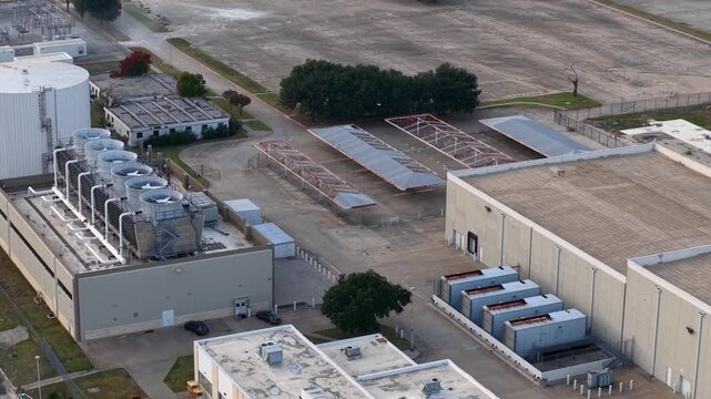 Aerial view of an industry or data center with cooling towers and fans.