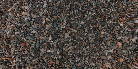 panorama view from above on surface of small pebbles and stones on sea coast
