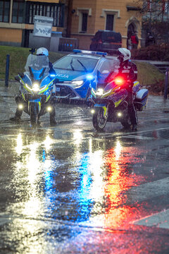 Motocyklista policjant na patrolu w mieście wieczorem. 
