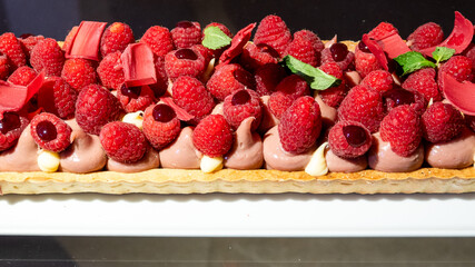 Fruit tart with pastry cream topped with fresh strawberries, raspberries, and mixed berries. A colorful and delicious Italian dessert, perfect for pastry lovers and gourmet photography.