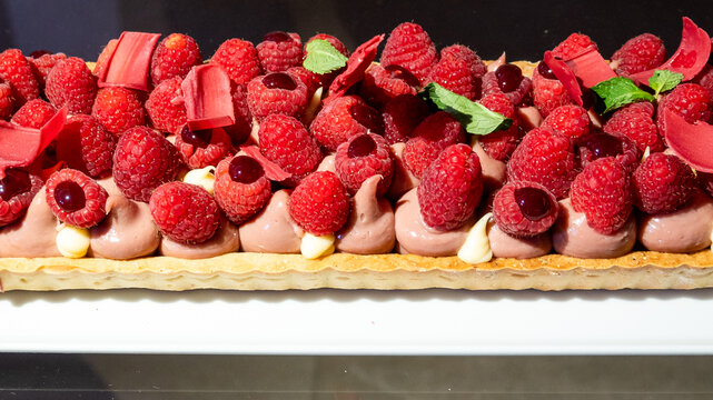 Fruit tart with pastry cream topped with fresh strawberries, raspberries, and mixed berries. A colorful and delicious Italian dessert, perfect for pastry lovers and gourmet photography.