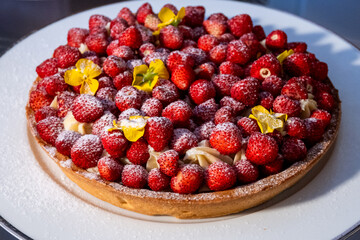 Fruit tart with pastry cream topped with fresh strawberries, raspberries, and mixed berries. A colorful and delicious Italian dessert, perfect for pastry lovers and gourmet photography.