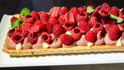 Fruit tart with pastry cream topped with fresh strawberries, raspberries, and mixed berries. A colorful and delicious Italian dessert, perfect for pastry lovers and gourmet photography.