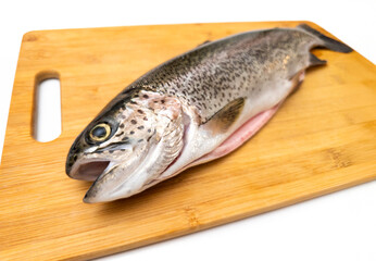 A fish is on a wooden cutting board