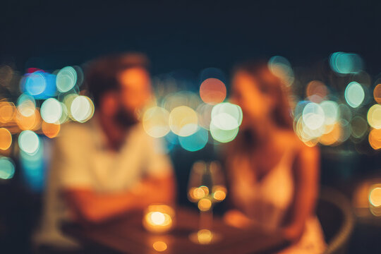 Defocused couple laughing with drinks blurred city nightscape romantic evening warm lights intimate atmosphere joyful mood outdoor setting urban background