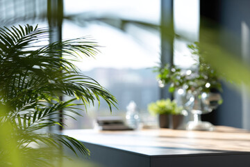 Fototapeta premium Modern office with natural light, green plants, wooden desk, glass decor, and blurred city view creates calm, productive, and refreshing workspace atmosphere