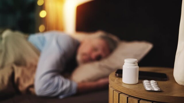 Middle-aged male sleeping in bed after taking prescribed sedative medication