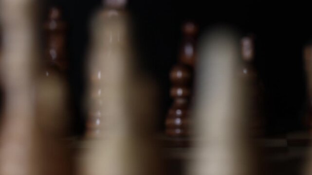 Animated sequence showing chess pieces on revolving board, capturing the essence of strategic decision-making and the black versus white dichotomy in chess