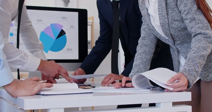 Business people close up hands analyzing marketing research charts on paper document, developing economic growth strategy, managing working processes in office, finance screen data presentation  - Powered by Adobe