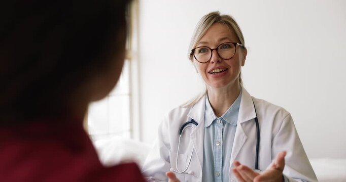 Doctor providing explanation and health recommendations to patient, closeup