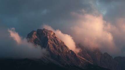 Landscape photograph of a mountain peak. the peak is covered in a thick layer of fog, with the fog covering the entire top of the mountain.