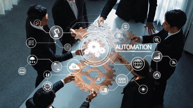 A diverse team collaborates on automation strategies, featuring digital interfaces and gear symbols that represent innovation and modern business solutions in a professional setting. Raster