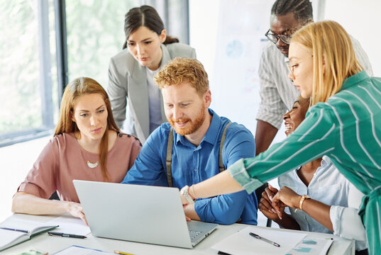 Group of young business people using laptop having a meeting or presentation and seminar in the office - Powered by Adobe