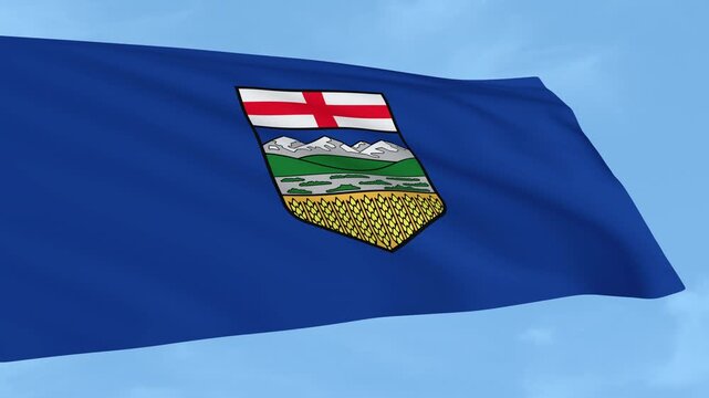 Flag of Alberta waving under a clear blue sky