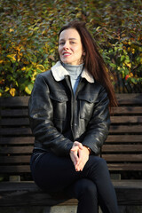 Happy Stylish Woman in Leather Jacket on City Street