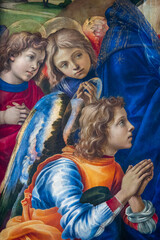 Painting (15th century) of angels in adoration and prayer.