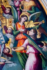 Painting (19th century) of a group of musician angels playing music.