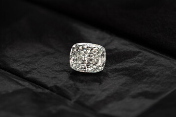 A diamond is sitting on a black cloth