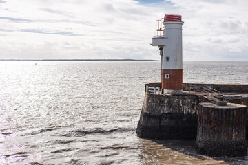 the Royan ferry terminal ramp extending towards a small lighthouse beacon visible to the right.