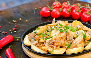 Roasted baked chicken thigh with pumpkin and potato wedges, garlic and aromatic herbs. Tasty autumn comfort food, ideas for Thanksgiving family dinner. High quality