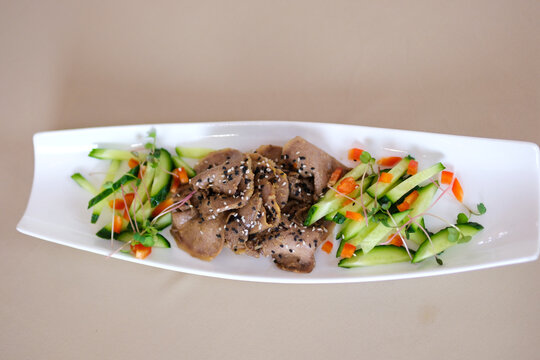 marinated beef tongue, cucumbers, bell peppers presenting a colorful beef salad dish. High quality 4k footage