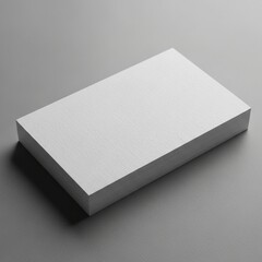 Clean Stack of Blank White Textured Cards on a Minimal Grey Surface