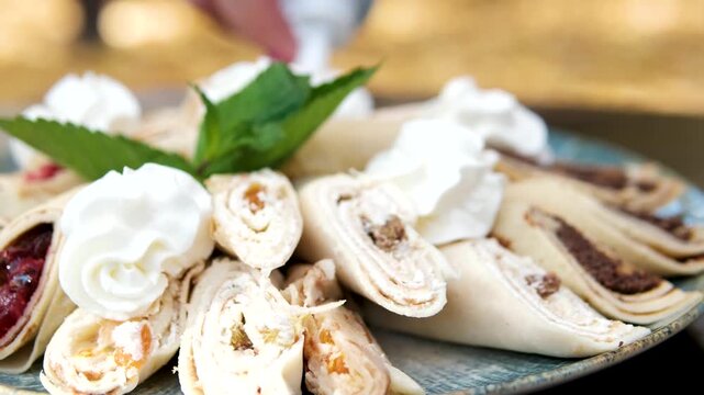 Thin pancakes with cherry cheese, add cream. High quality 4k footage