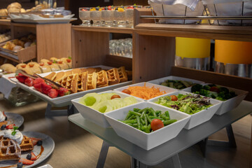 Breakfast buffet with a variety of breads, cereals, yogurt, and desserts