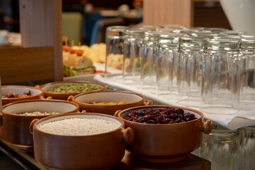 Breakfast buffet with a variety of breads, cereals, yogurt, and desserts