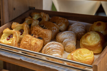 Breakfast buffet with a variety of breads, cereals, yogurt, and desserts