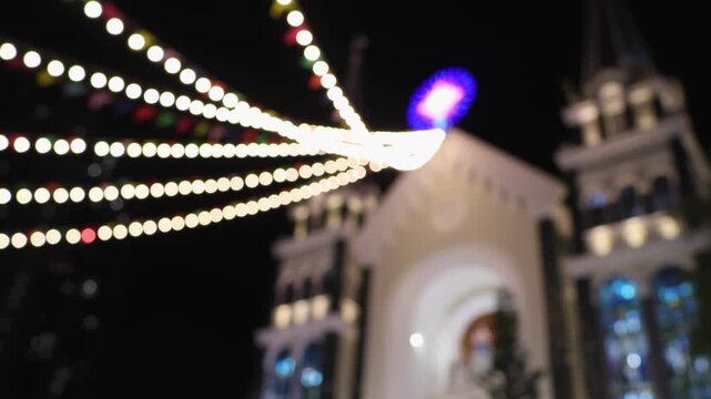 Bokeh view of Ba Lang catholic church on Christmas Eve, Nha Trang, Vietnam. Blurred background footage.