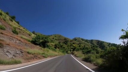 premium 4k drone footage tranquil road winding gently green hills Harihareshwar Maharashtra under brilliant sunlight showcasing serene travel routes lush nature rural Indian beauty