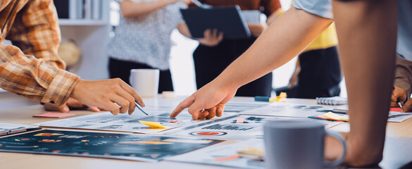 A dynamic scene of teamwork in a modern office, featuring hands engaged in collaborative strategy...