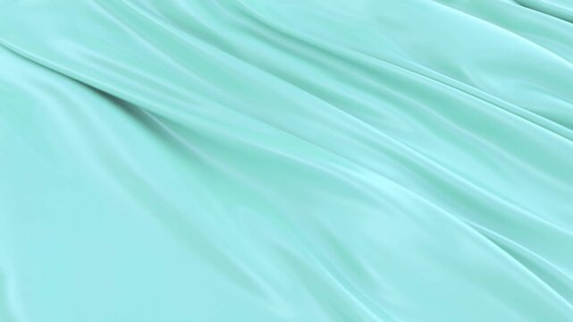 Elegant flowing turquoise fabric creates a modern and vibrant background, perfect for adding a touch of luxury to your next project or design