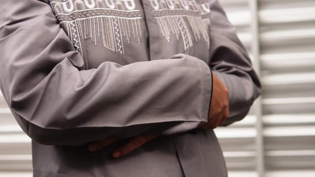 A Muslim man performing a prayer movement. Islamic worship movement. Procedure of prayer. Does not show the face.