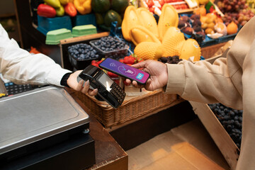 Mobile Payment at Grocery Market, Person Using Smartphone to Pay for Fresh Fruits