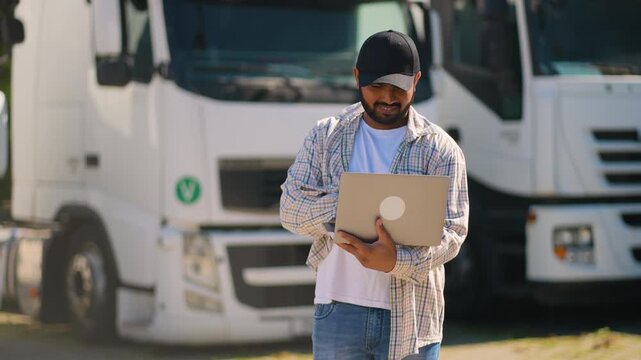 Truck driver managing fleet logistics with laptop