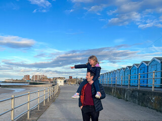 Father and Daughter Enjoying Seaside Walk