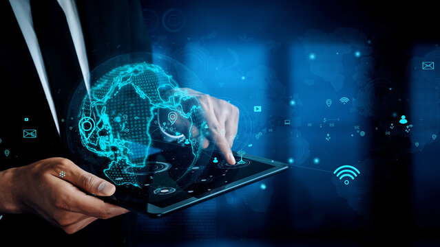 A business professional engages with a holographic globe on a tablet device, set against a futuristic digital background, symbolizing innovation and connectivity. Xenic