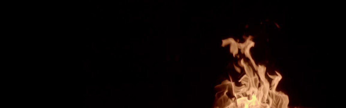 Anamorphic video: bonfire on black background