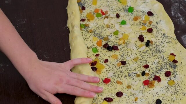 baking for Christmas Easter Making homemade cruffin step by step, rolling yeast dough, spreading butter and poppy seeds, adding dried fruits, baking layered cruffins, cooking process in the kitchen