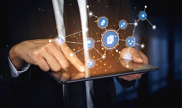 A businessman engages with a digital tablet showcasing data networks and connection icons, representing innovation and modern technology in communication. Tessel
