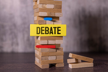 Debate, text on wood blocks. on wood background.