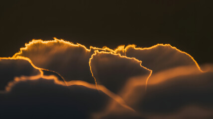 Golden sunset cloud rim light on black background, abstract glowing orange edge texture, dramatic dark sky atmosphere wallpaper, for weather, mood, cinema, mystery.